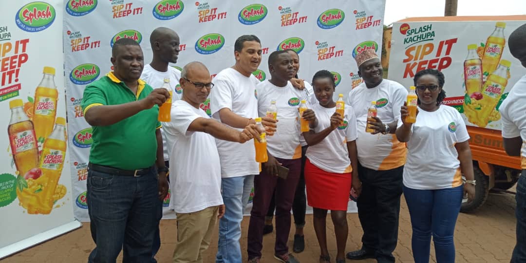 Allied Uganda Team  displays bottles of Splash Kachupa