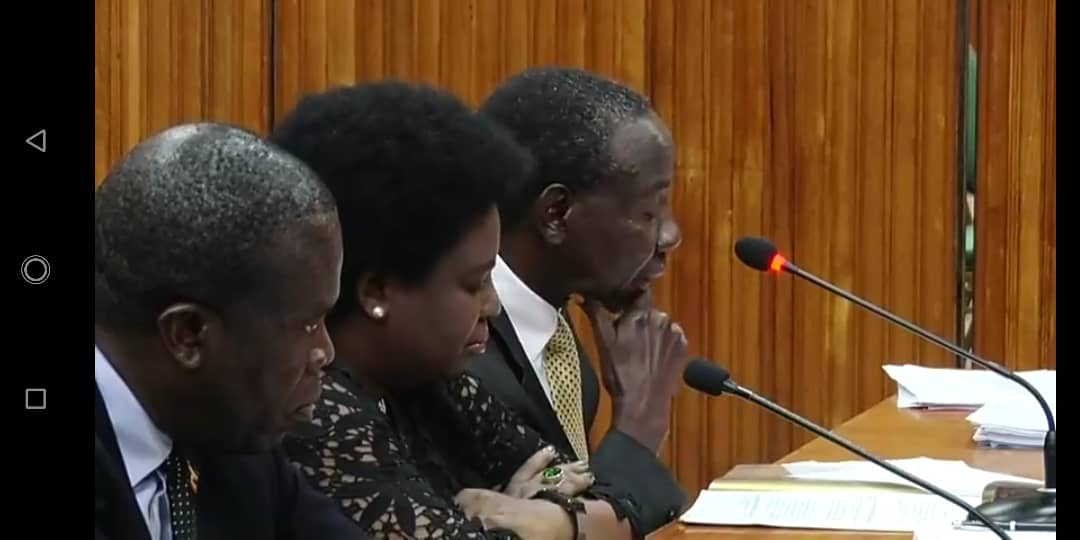 Minister Matia  Kasaija with others in Parliament