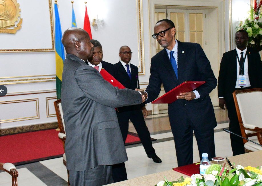 Presidents Museveni and Paul Kagame shake hands