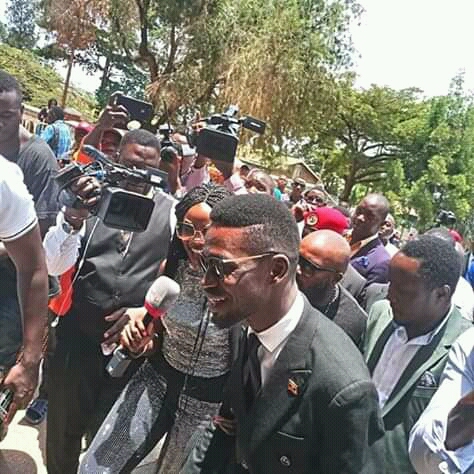 Bobi Wine and other celebrities talking to the press after mass