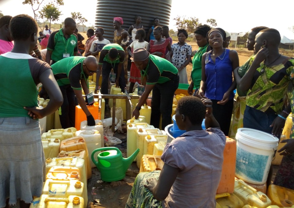 PAP Team helping Refugees to fetch Water