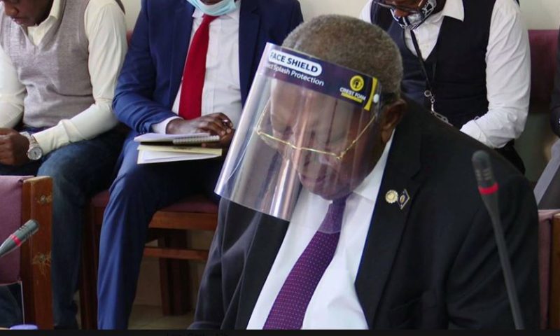 BoU Governor Mutebile Takes Fight Against COVID-19 To Another Level, Wears Glass Shield Not Mask