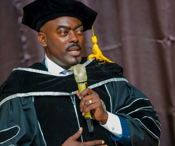 Hon Fred Mukasa Mbidde’s English Thrills Whites As He Scoops Honorary Doctorate At Zoe Life Theological College USA